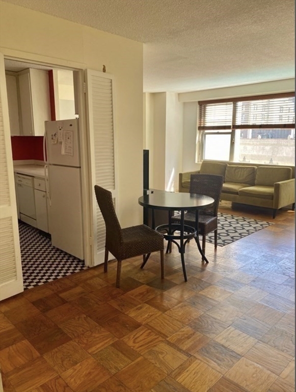 151 Tremont Street, Unit 9S Boston, MA 02111 - Photo 10 of 11 a view of a livingroom with furniture and window