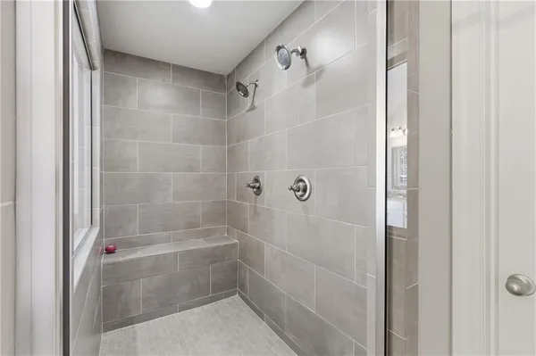 a bedroom with a bed and a ceiling fan