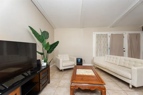 a living room with furniture and a potted plant