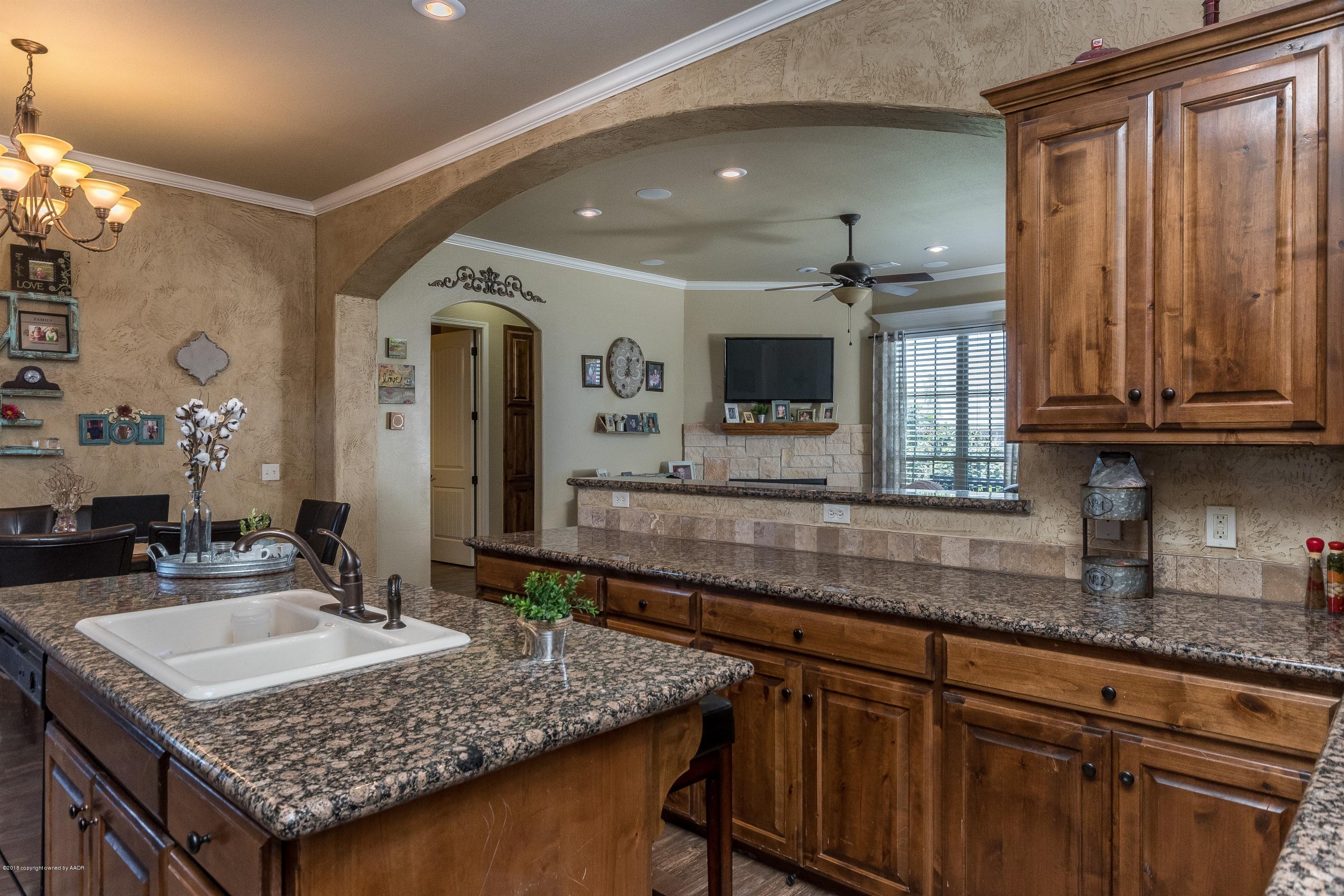 3909 Arden Road Amarillo, TX 79118 - Photo 8 of 20 a kitchen with granite countertop kitchen island sink and cabinets