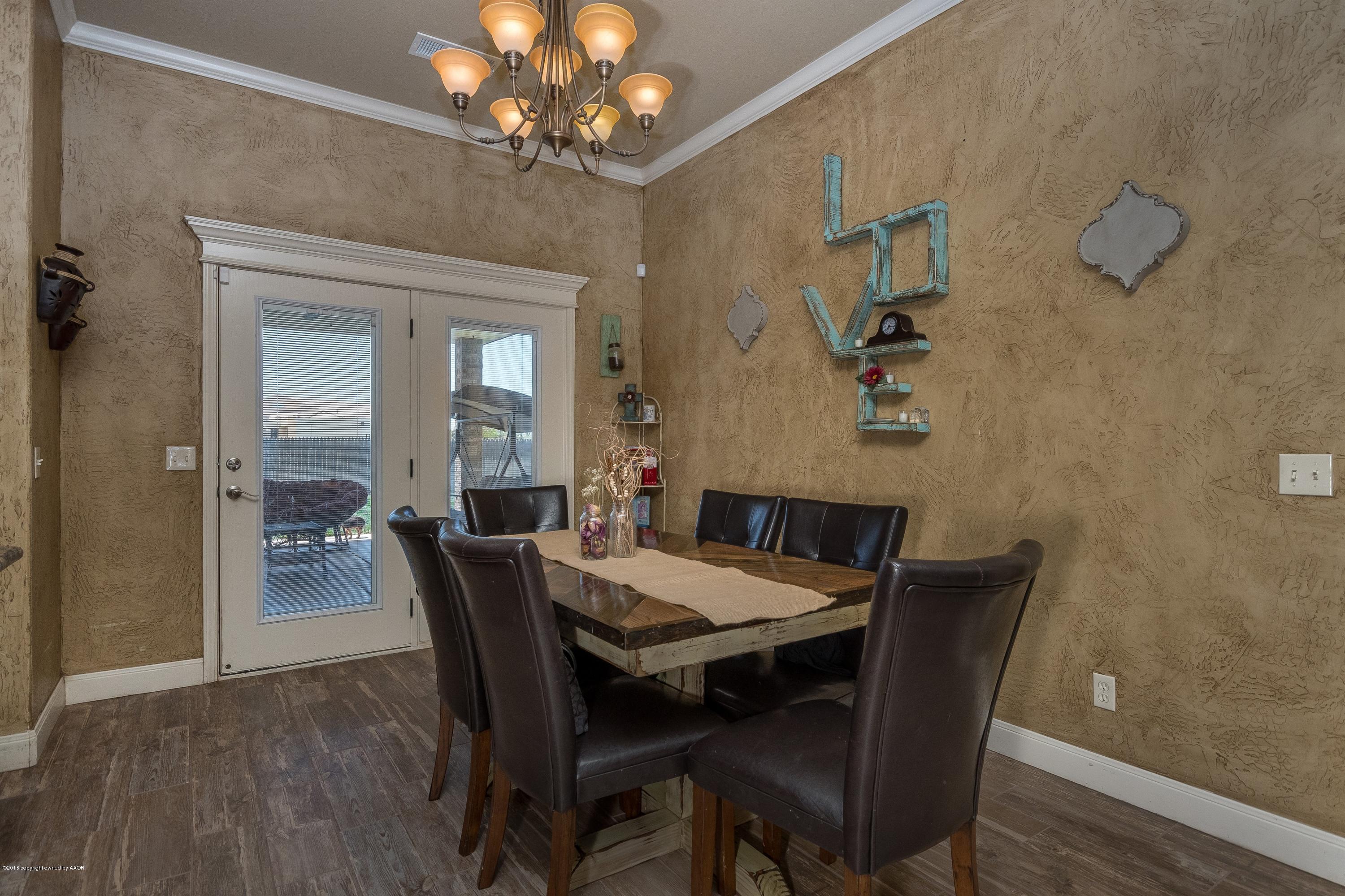 3909 Arden Road Amarillo, TX 79118 - Photo 10 of 20 a view of a dining room with furniture wooden floor and a chandelier