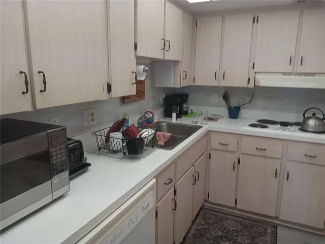 a kitchen with a refrigerator and cabinets
