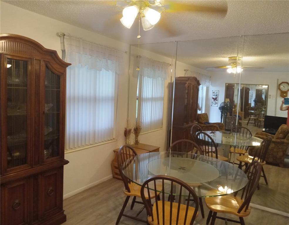 2467 Finlandia Lane, Unit 27 Clearwater, FL 33763 - Photo 19 of 58 a dining room with furniture and window