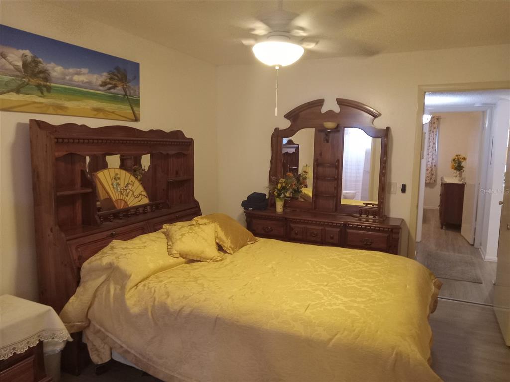2467 Finlandia Lane, Unit 27 Clearwater, FL 33763 - Photo 23 of 58 a bedroom with a bed and a mirror