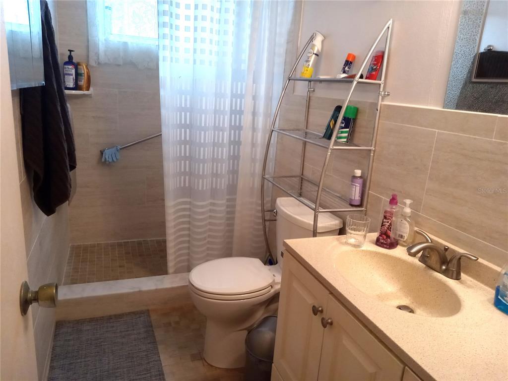 2467 Finlandia Lane, Unit 27 Clearwater, FL 33763 - Photo 27 of 58 a bathroom with a sink toilet and shower