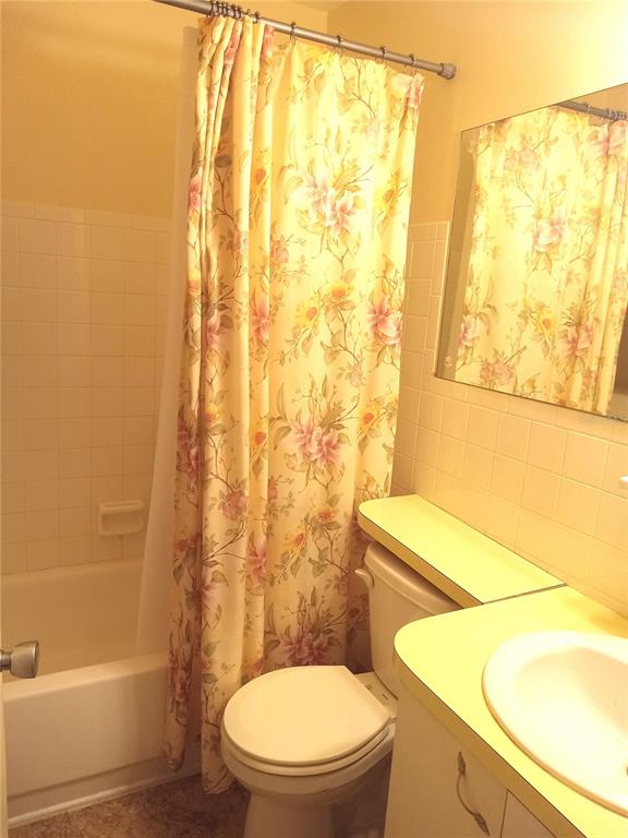 2467 Finlandia Lane, Unit 27 Clearwater, FL 33763 - Photo 30 of 58 a white toilet sitting next to a bath tub and a shower