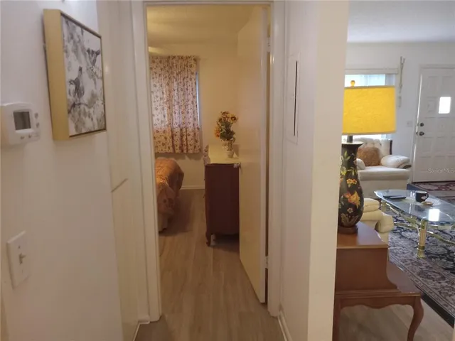 a bedroom with a bed and a mirror on dresser