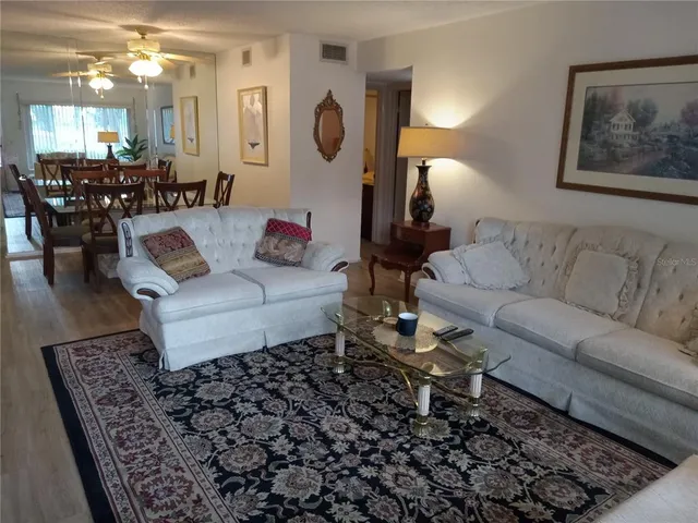 a living room with furniture and a chandelier