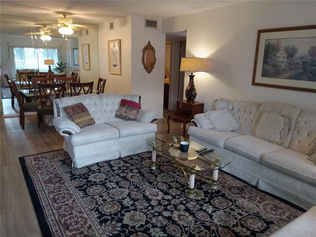 2467 Finlandia Lane, Unit 27 Clearwater, FL 33763 - Photo 5 of 58 a living room with furniture and wooden floor