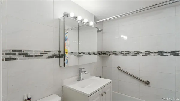 a bathroom with a sink a mirror and a shower