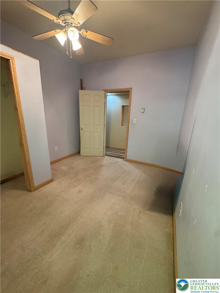 134 Bear Road Kunkletown, PA 18058 - Photo 35 of 42 High ceilings and neutral carpeting define this versatile interior space with wood-trimmed doorways.