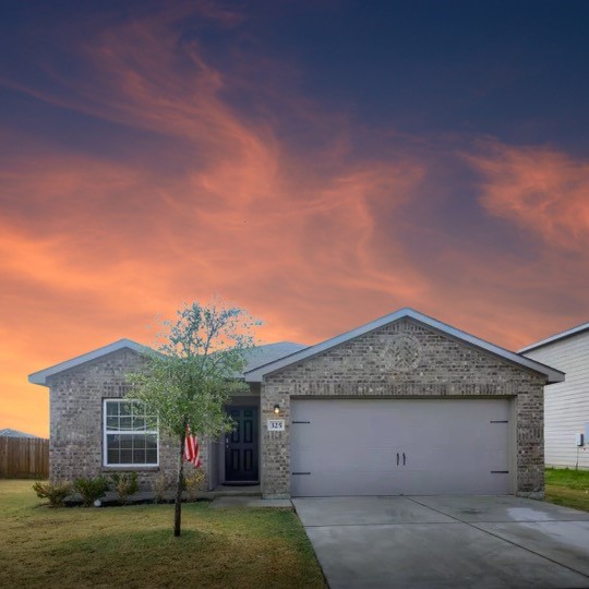 a front view of a house with a garden and yard
