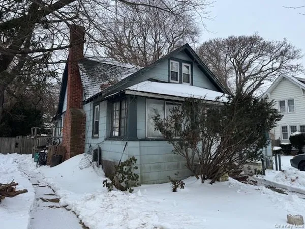 a view of a house with a yard covered in snow