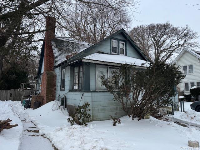 2122 Walnut Street Baldwin, NY 11510 - Photo 2 of 32 a view of a house with a yard covered in snow