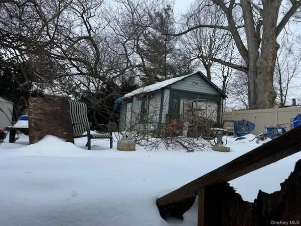 a view of a backyard with table and chairs under an umbrella