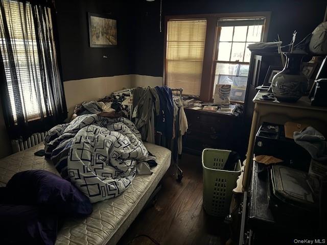 2122 Walnut Street Baldwin, NY 11510 - Photo 10 of 32 a bed sitting in a bedroom next to a window and chair