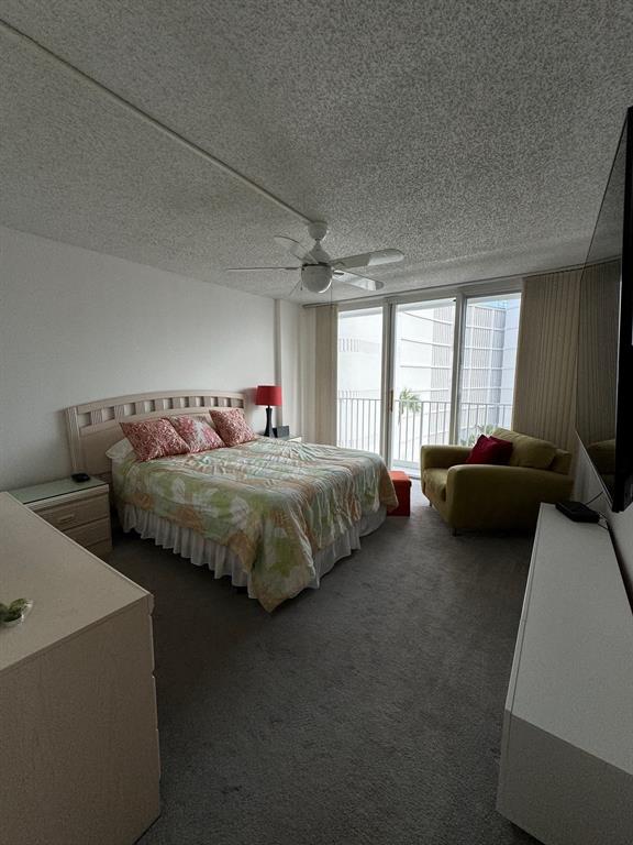 3580 South Ocean Boulevard, Unit 6C South Palm Beach, FL 33480 - Photo 5 of 12 a bedroom with bed couch and a large window