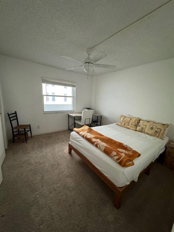 3580 South Ocean Boulevard, Unit 6C South Palm Beach, FL 33480 - Photo 6 of 12 a bed sitting in a room next to a window