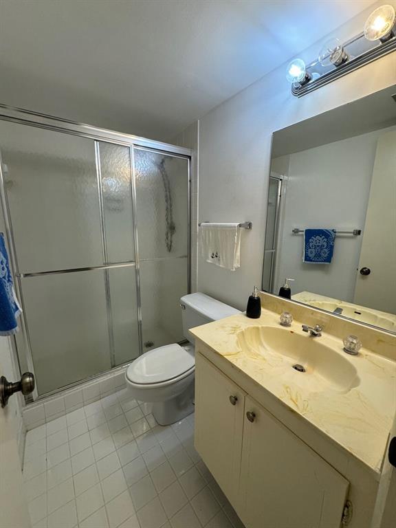 3580 South Ocean Boulevard, Unit 6C South Palm Beach, FL 33480 - Photo 9 of 12 a bathroom with a sink toilet and shower