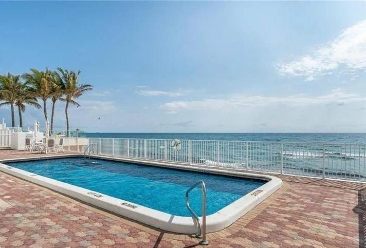 3580 South Ocean Boulevard, Unit 6C South Palm Beach, FL 33480 - Photo 10 of 12 a view of a swimming pool with a chair