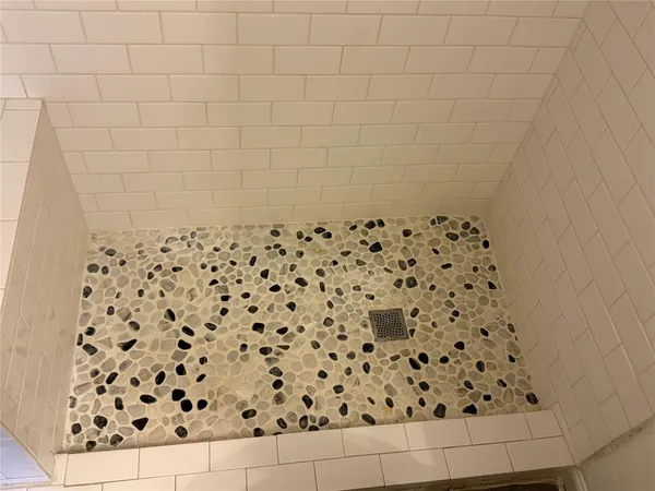 a bathroom with a black white checkered floor
