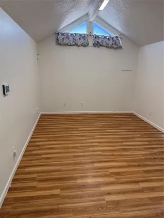 a view of a room with wooden floor