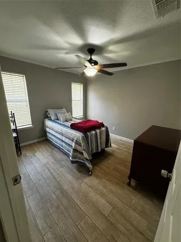 a bedroom with bed and a window
