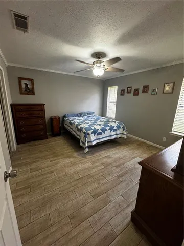 a bedroom with a bed and a ceiling fan