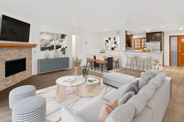 a living room with furniture a fireplace and a flat screen tv