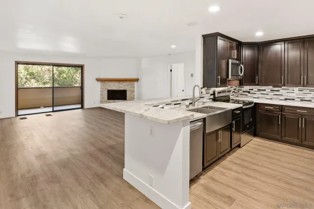 a kitchen with a stove a sink and a refrigerator