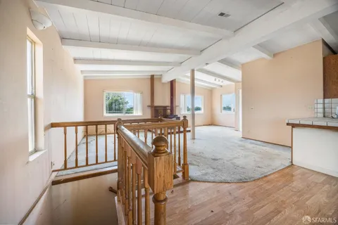 a view of a room with wooden floor