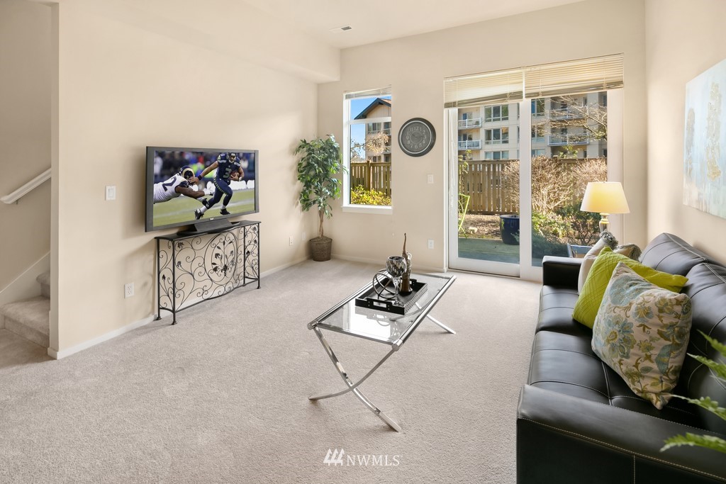 70 Cougar Ridge Road Northwest, Unit 2004 Issaquah, WA 98027 - Photo 22 of 27 a living room with furniture and a flat screen tv