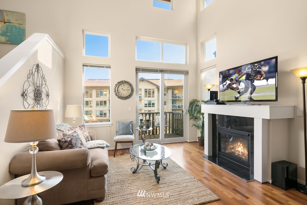 70 Cougar Ridge Road Northwest, Unit 2004 Issaquah, WA 98027 - Photo 5 of 27 a living room with furniture a flat screen tv and a fireplace