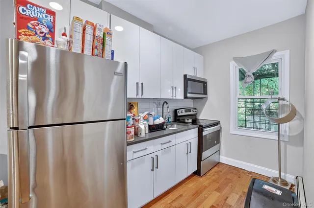 a kitchen with stainless steel appliances a refrigerator sink and cabinets