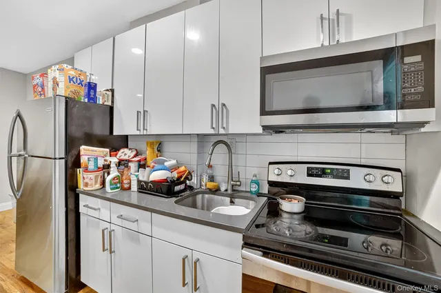 a kitchen with a microwave a stove and cabinets