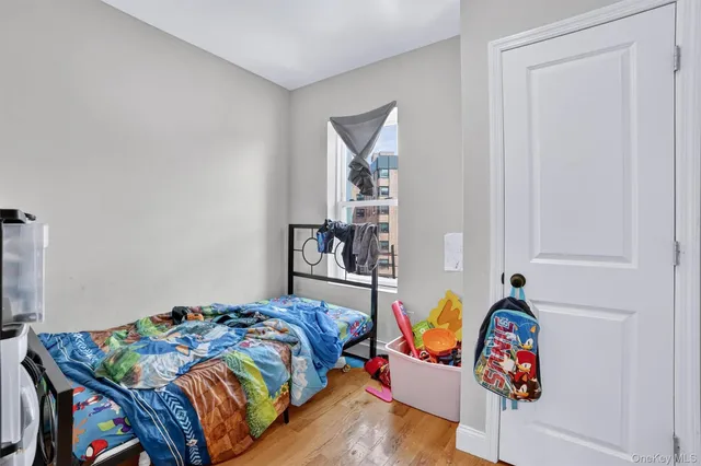 a bedroom with bed and book shelf