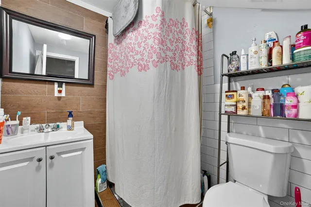 a bathroom with a sink vanity mirror and toilet