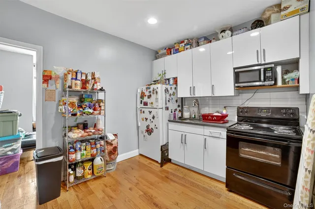 a kitchen with stainless steel appliances a stove a sink and a refrigerator