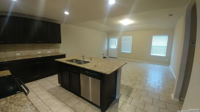 a kitchen with a sink and a stove top oven