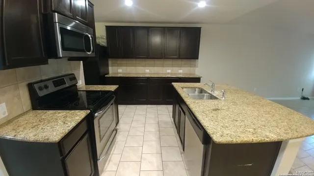 a kitchen with a stove and a sink