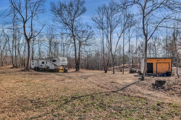 a backyard of a house with parked cars