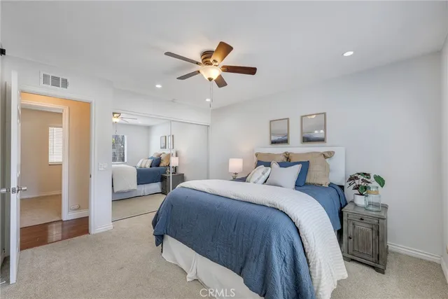 a bedroom with a bed and ceiling fan