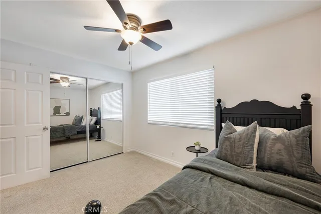 a bed room with a bed and a chair