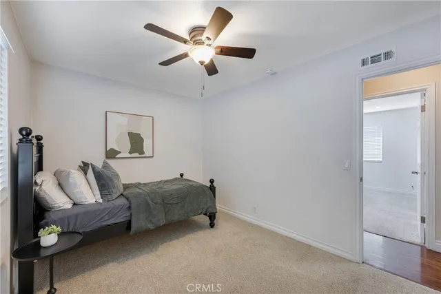 a living room with furniture and a ceiling fan