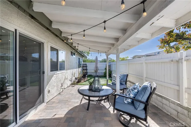 a balcony with furniture and a potted plant