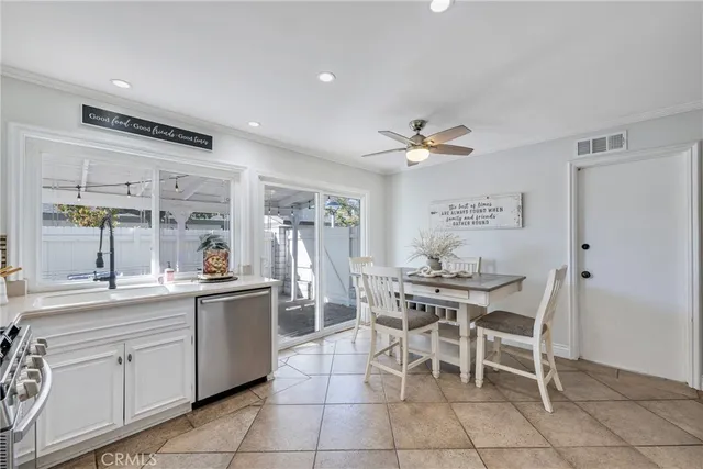 a dining hall with stainless steel appliances a table and chairs