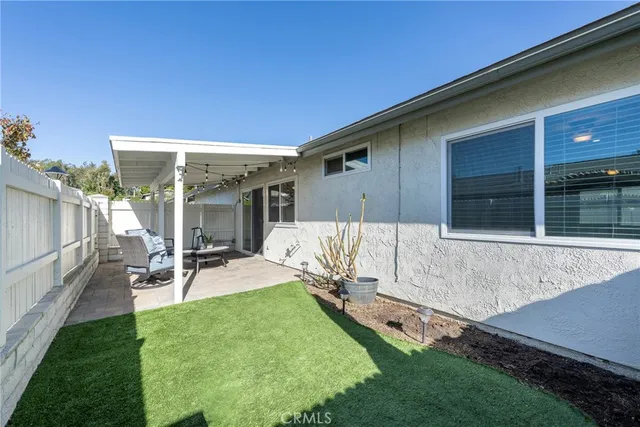 a view of a backyard with chair and table
