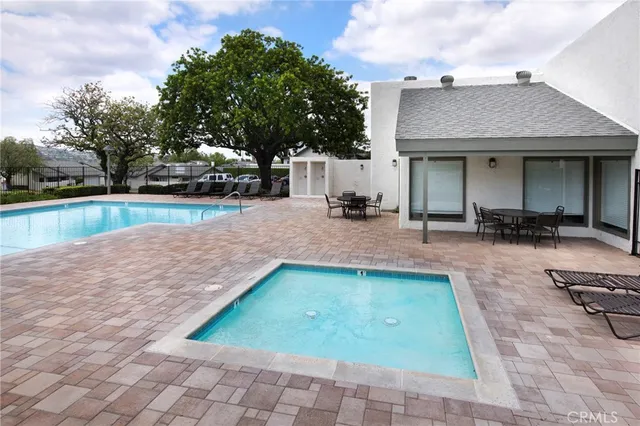 a view of a backyard with swimming pool