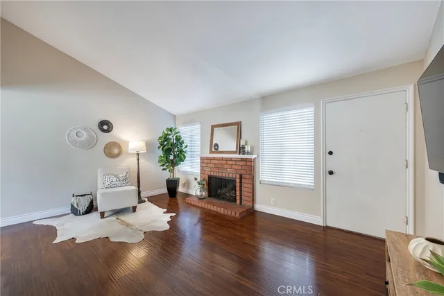 a living room with furniture a fireplace and a flat tv screen