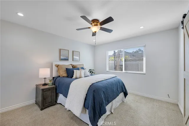 a bed room with bed and a chandelier